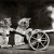 1914. `Cats in coveralls, posed as if firing a toy cannon.`